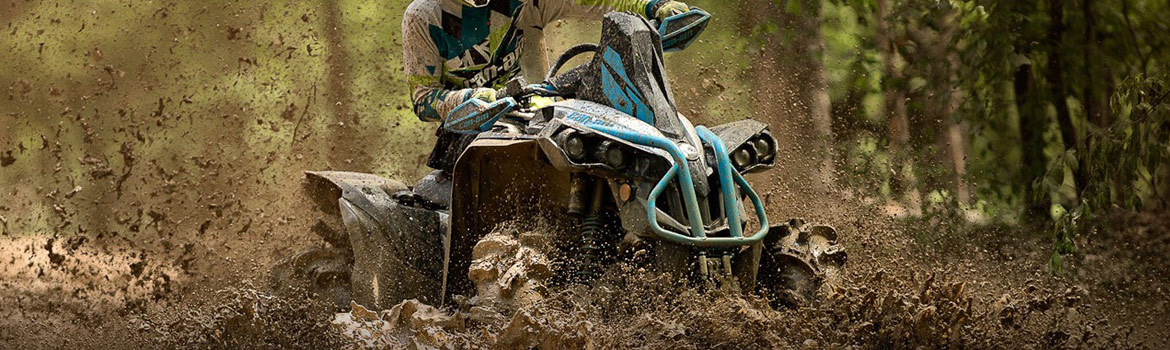 A 2017 Can-Am® Renegade® X® MR atv being driven through the mud